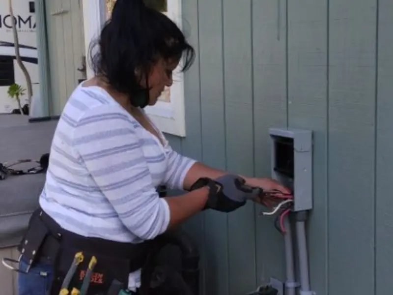 Licensed electrician wiring an exterior subpanel in Vado